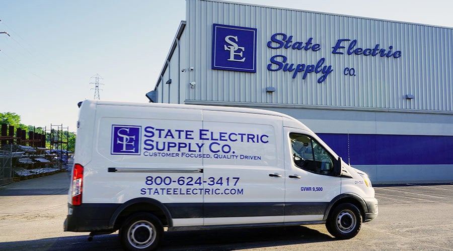 state electric van parked in front of a state electric building