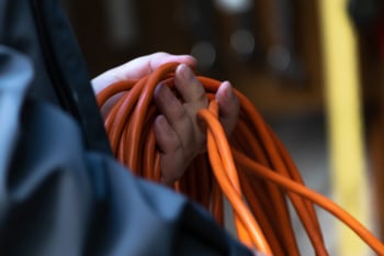 orange extention cord ready to use to plug in electric items outside