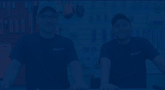 blue overlay image with two men standing behind a retail counter