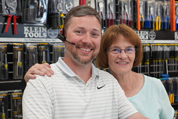 man and a woman standing next to each other in a retail space